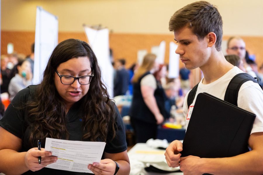 Employer reviewing student's resume at tabling event