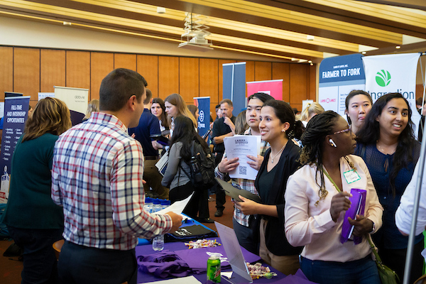 Students speaking with employers at vendor tables