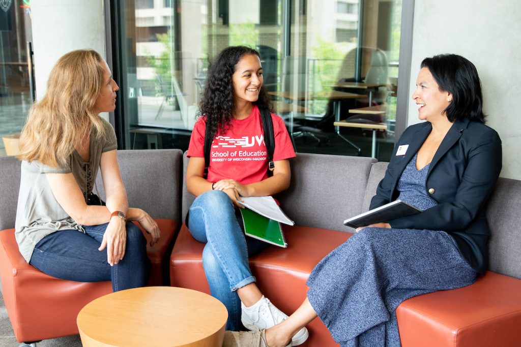 two students talking to a UW staff member