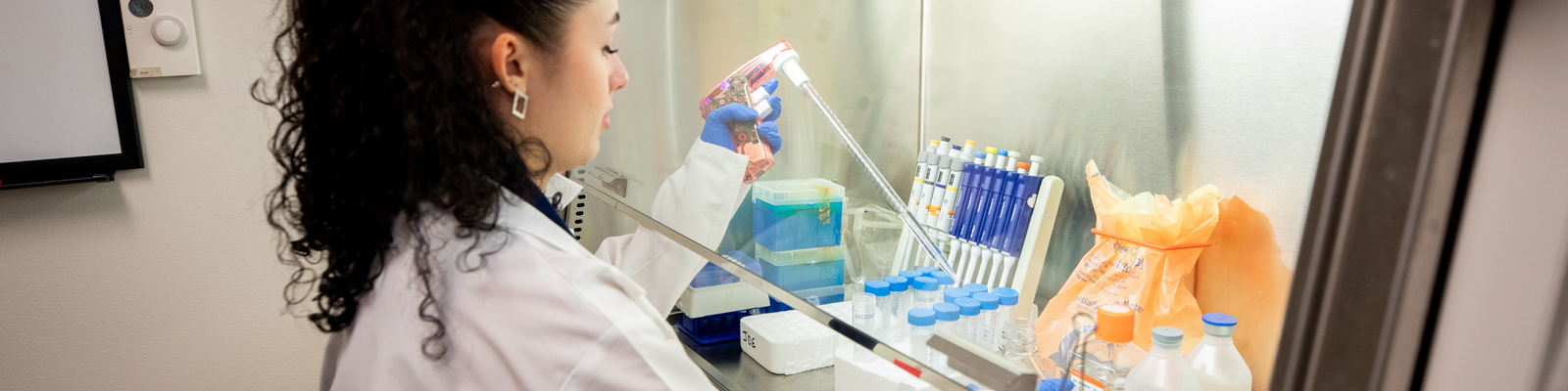 UW Madison Student testing beakers in a lab