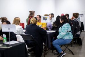 Students seated at various employer tables