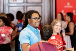 Students mingling and speaking with alumni