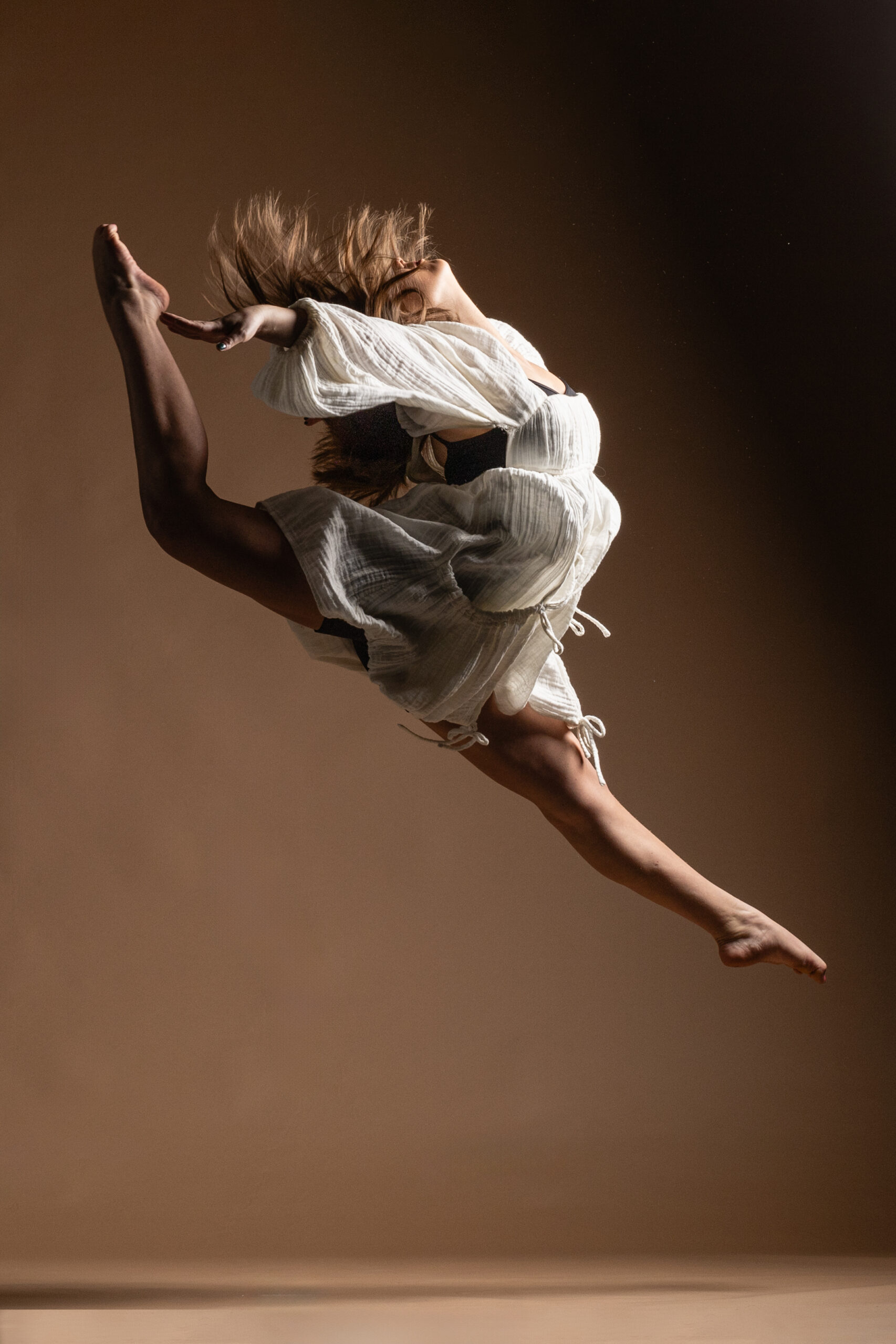 UW Madison dancer performing a firebird jump