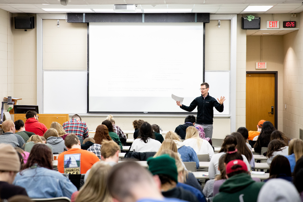 a professor presenting in front of a classroom