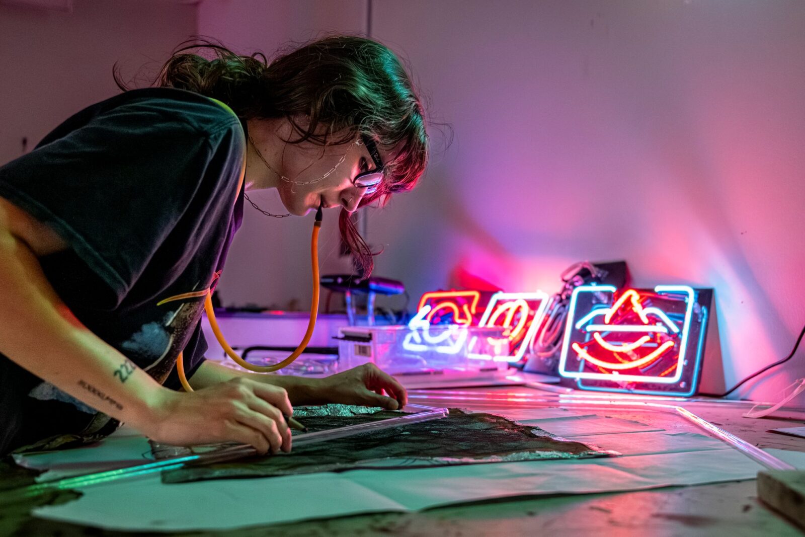 a person working with glass and neon