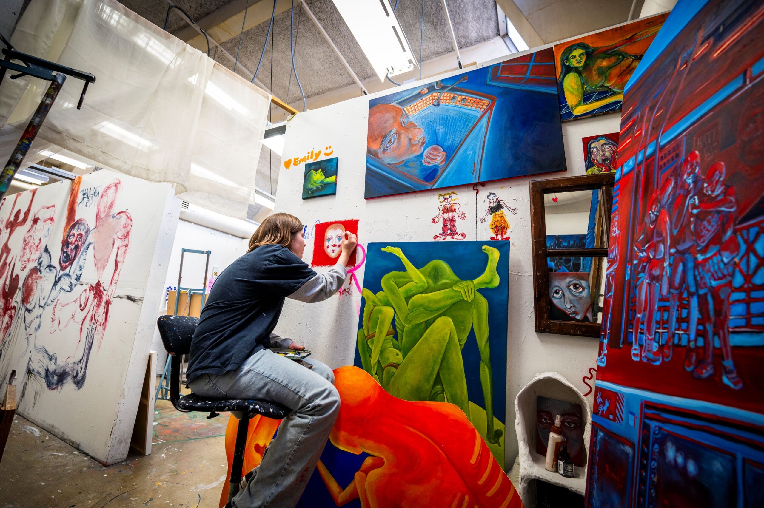 an artist painting in a studio
