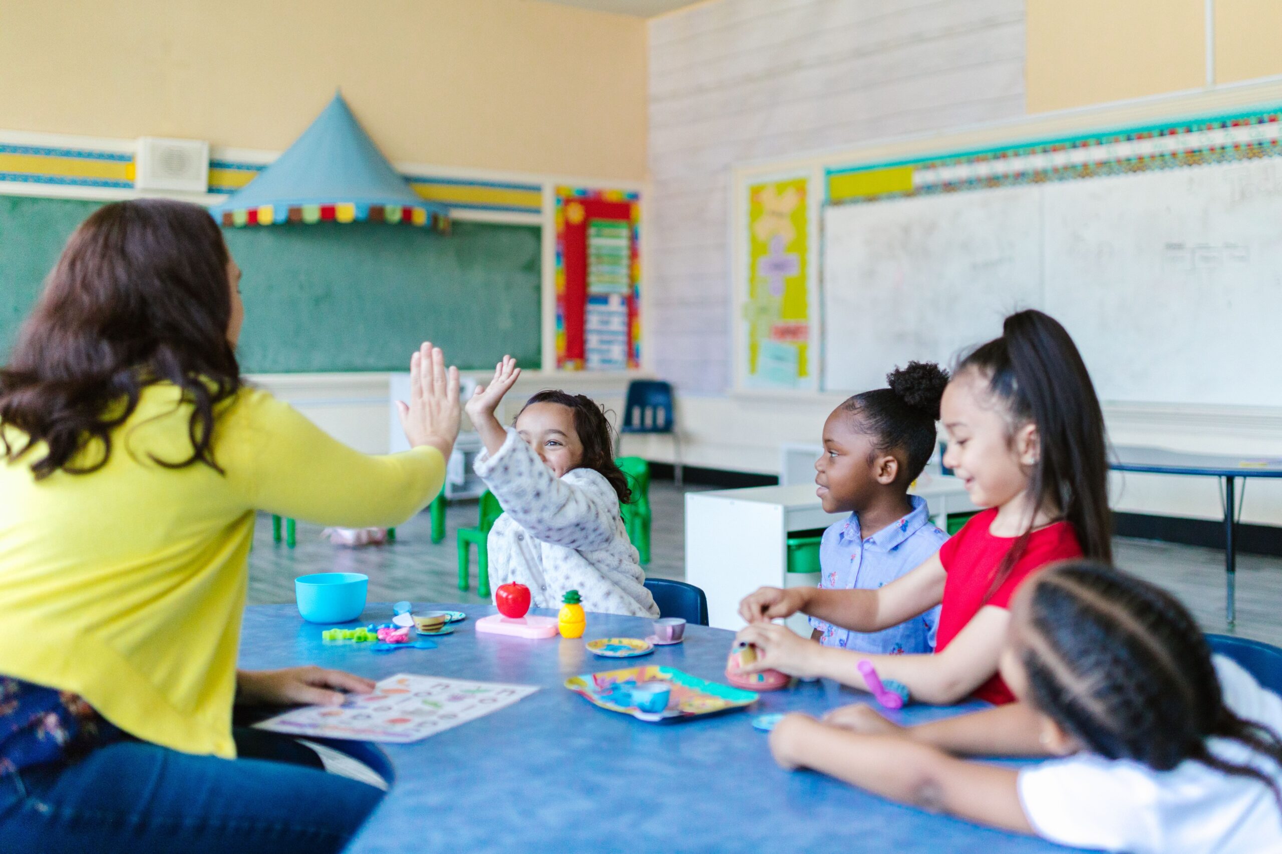 a teacher working in a classroom with children