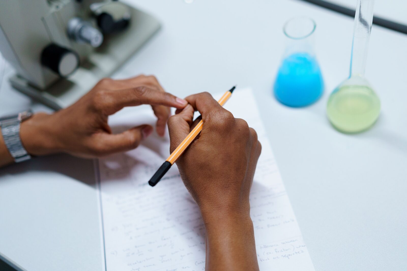 a person's hands holding a pencil